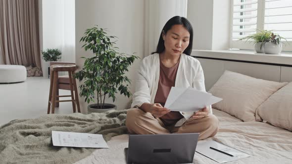 Asian Freelancer Posing on Bed alt