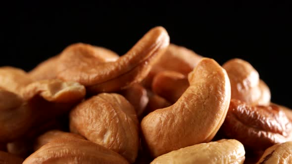 Video of cashews nut rotates slowly. Closeup shot in 4K resolution. Healthy food alt
