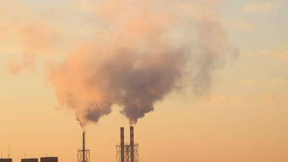 Timelapse. Smoke comes out of the production chimney of the plant. Environmental pollution