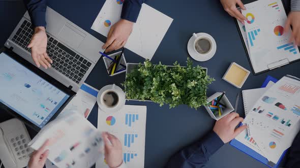 Top View of Business Group Analyzing Company Infographics Documents alt