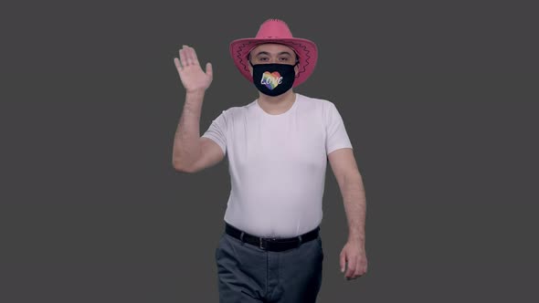 Homosexual Man in Anti Covid Lgbt Mask and Pink Hat Walks Saying Hello, Alpha in