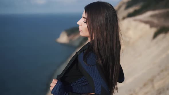 Slow Motion Side View of Sexy Young Athletic Woman Taking Off Her Jacket alt