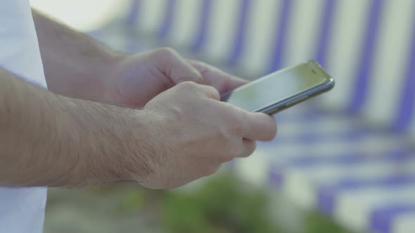 Male Hands Texting on Smartphone alt