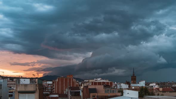 Dramatic Storm Clouds Rolling Over Badalona Town at the Sunset
