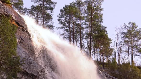 Protected waterfall Hesjedalsfossen in western Norway - Idyllic afternoon static clip with warm sunl alt