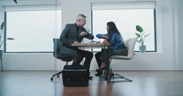 Agent touch elbows with couple and giving them key to their new home alt