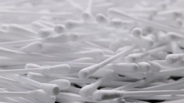 Pile of Qtips or Cottom Buds Slowly Rotating on Black Background alt