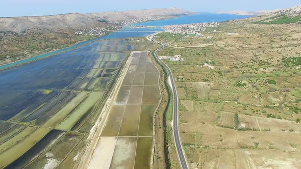 Aerial view of salt pans surrounded by sea and mountains, Pag island, Croatia alt