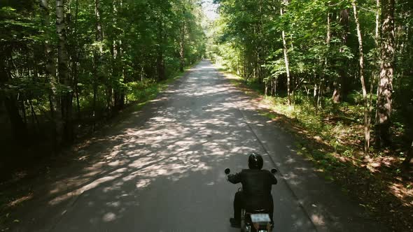 Two Motorcyclists Riding Motorbikes in the Forest alt
