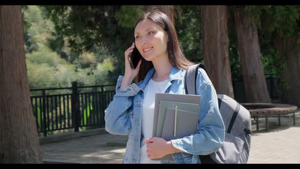 Young Student Girl Talking By the Phone