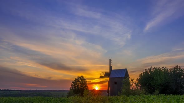 Sunrise and an Old Wooden Windmill