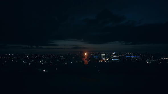 Young Blond Male Spins Burning Torch Breathes Out Large Stream of Fire Makes Fireball Touches Burned alt