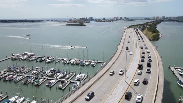 rising aerial view of Clearwater, Florida Causeway Bridge going to Clearwater Beach.  Busy day of st alt