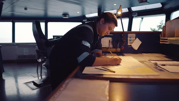 Marine Navigational Officer During Navigational Watch on Bridge . He Does Chart Correction alt