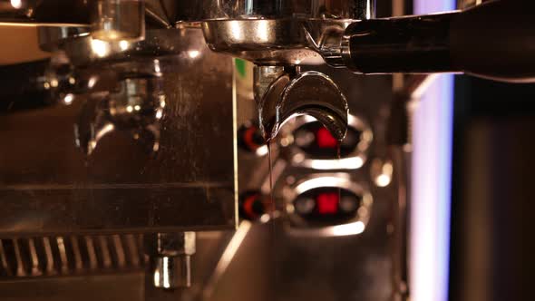 Pouring coffee stream from professional machine in cup. Flowing fresh ground coffee. alt