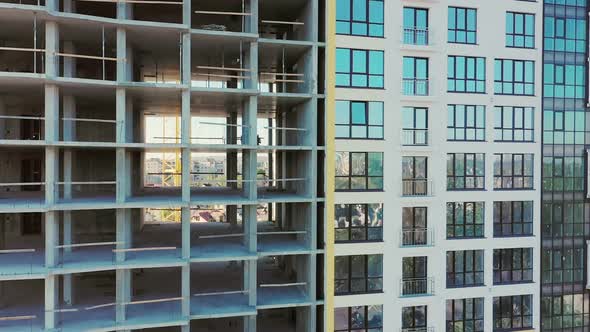 Many windows on new apartment building facade under construction alt