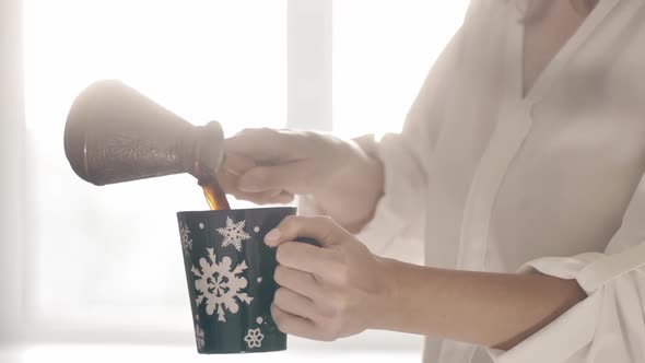 Woman Pours the Hot Coffee in Cup alt