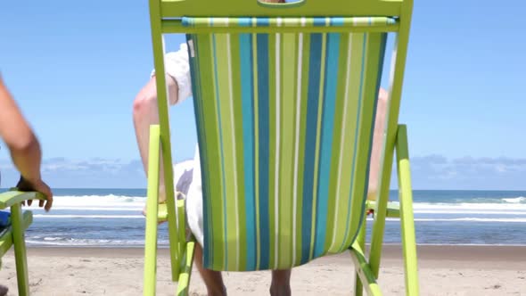 Couple running to beach alt