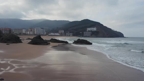 Aerial view of Bakio resort city; cloudy north Spain nature alt