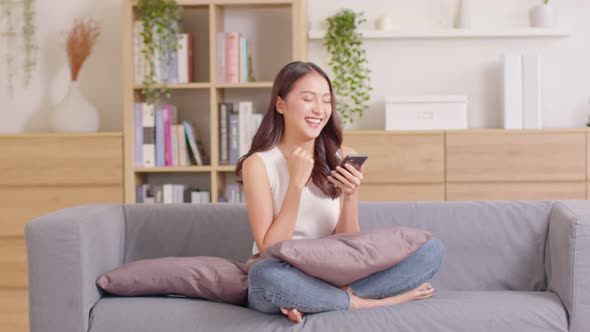 beautiful business asian young woman wear casual use mobile phone for shopping online laughing alt