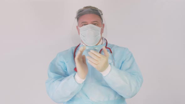 Doctor in personal protective equipment clapping their hands to cerebrate the success of treatment.