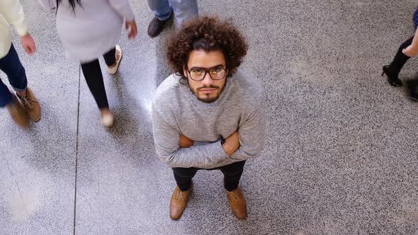 Portrait of business executive standing with arms crossed alt