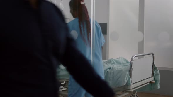 African American Nurse Bringing Healthy Nutrition Food Meal to Sick Patient alt