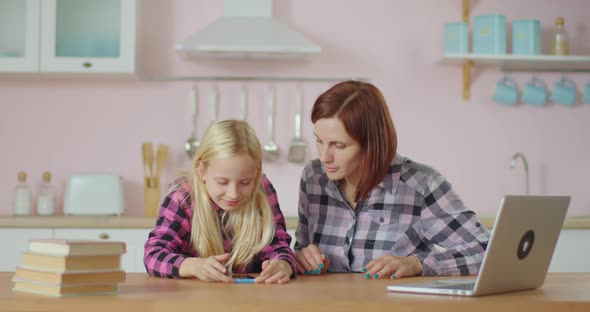 Little Blonde Cute Girl Recording Video for Popular Mobile Application and Teaching Young Mom. 30s alt