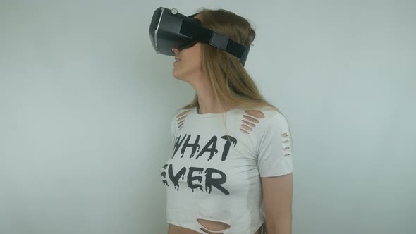 Sexy Woman Uses A Virtual Reality Helmet And Full Immersion Technology