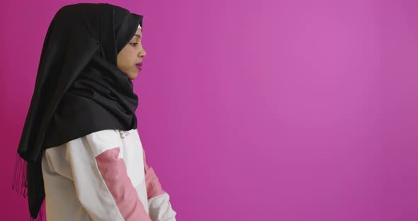 Muslim Woman in Hijab with Dumbbells Doing Exercises Over Color Background alt