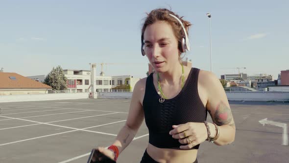 Young woman dancing on park deck alt