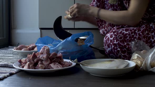 Close-up hands of women slicing  potatoes Using Pahsul or Boti. Locked Off alt