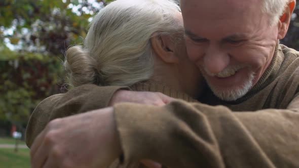 Aged Husband and Wife Hugging in Park, Family Connection, Tender Relations