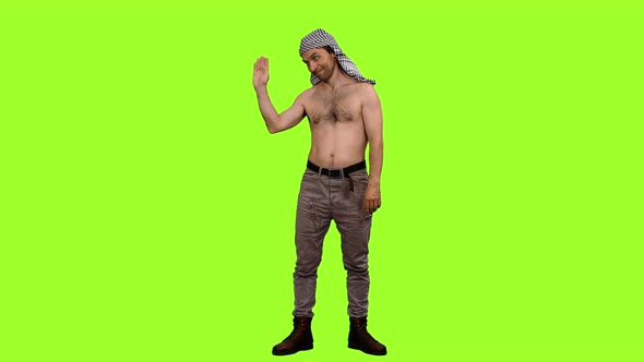 Friendly Man Stands and Waving Greetings on Green Background alt