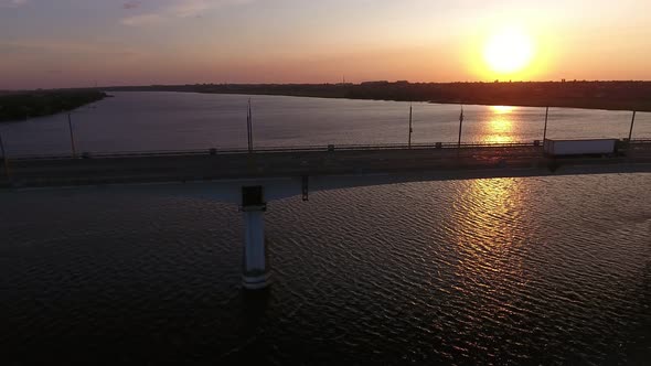 Aerial Shot of Big Bridge Covering the Dnipro at Shimmering Sunset in Summer