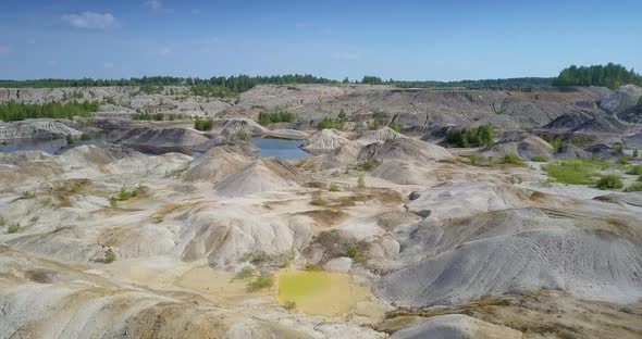 Aerial View White Clear Hills Near Lake in Spent Clay Quarry alt