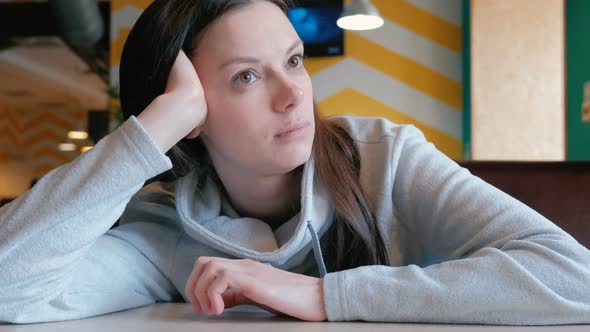 Sad Woman Sitting in a Cafe and Waiting Her Order