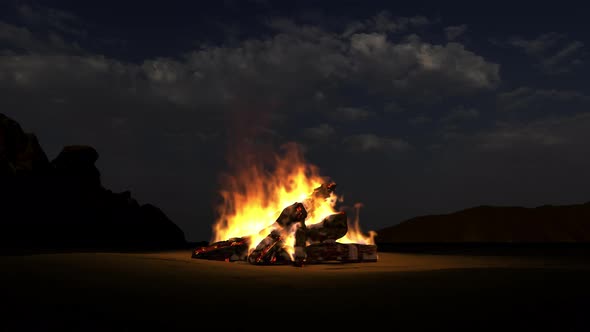 A bonfire burns in nature in the mountains in the desert.