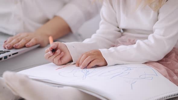 Toddler Girl and Mother Are Spending Time Together Sitting on the Sofa alt