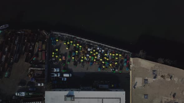Aerial Birds Eye Overhead Top Down Descending View of Logistic Facility on Waterfront alt