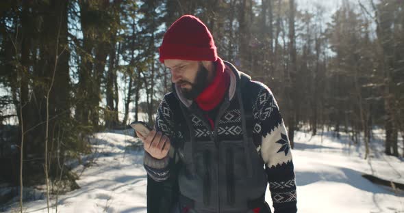 Tourist Lost in Forest Trying to Catch Connection on Mobile Phone alt