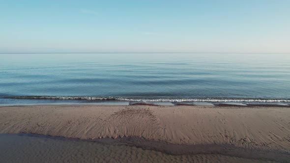 The camera slowly scrolls across the beach during sunrise.