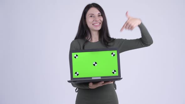 Happy Young Beautiful Woman Showing Laptop and Giving Thumbs Up alt