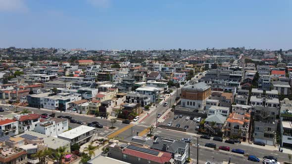 Aerial view overlooking the cityscape of Hermosa, in sunny Los Angeles, USA - rising, drone shot alt