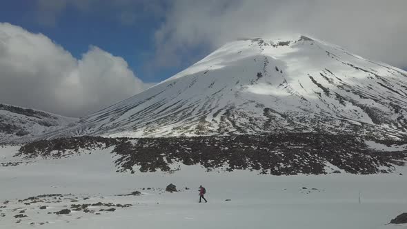 Hiker walking near volcano
