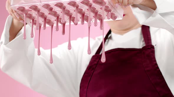 Closeup Dark Chocolate Dripping Down From Confectionery Mold, Candy Making alt