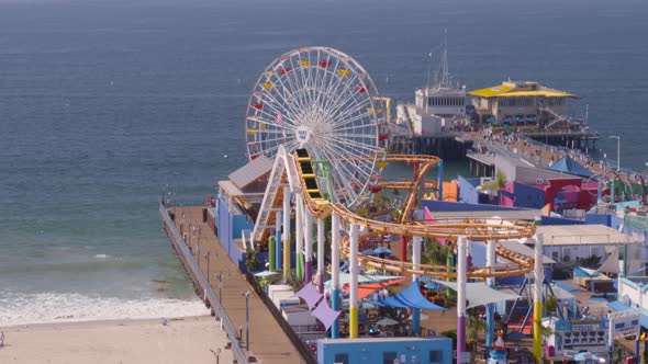 Aerial of Ferris wheel and amusement park rides at Pacific Park alt