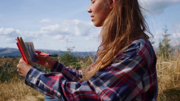 Woman Drawing Sketch in Notebook alt