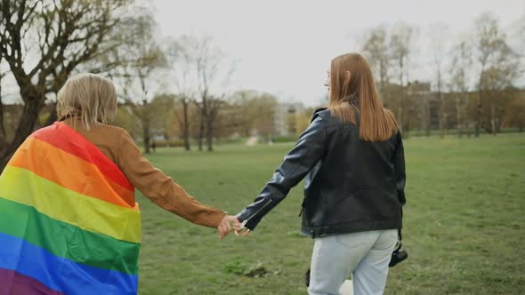 Playful Lesbian Woman Kisses and Runs Away From Her Partner Walking Their Dog alt