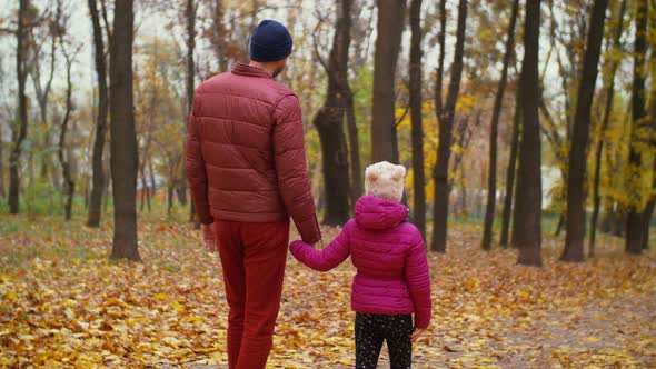 Positive Father and Daughter Relaxing in Autumn Forest alt